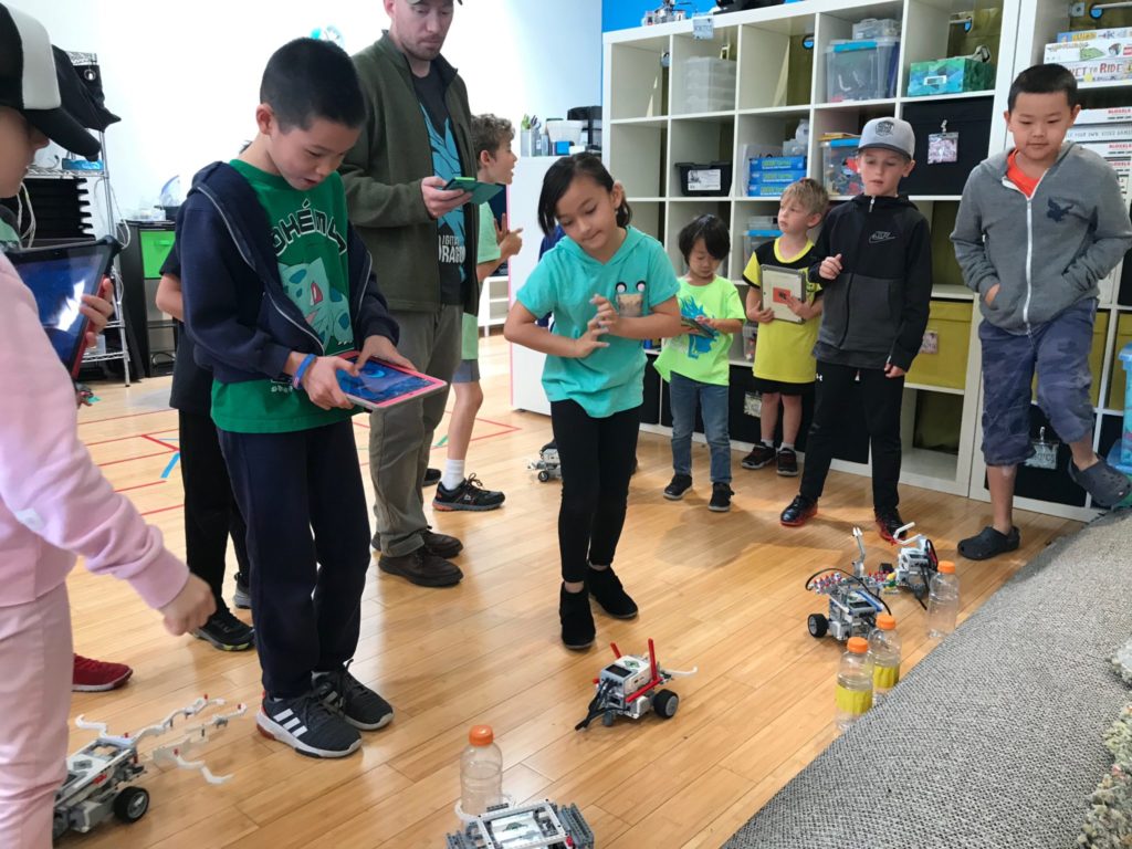 Kids Robotics Class where they design, engineer, build, and program robots to complete challenges and compete in battles.